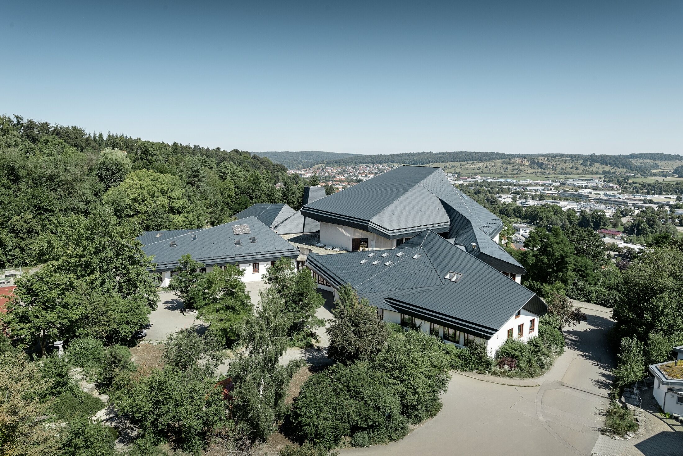 École Waldorf de Heidenheim au toit rénové — L’importante toiture aux nombreux angles, recoins et inclinaisons a été réalisée avec des bardeaux PREFA anthracite